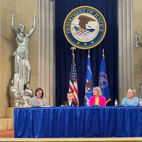 jennifer-mclelland-and-her-son-speaking-at-the-doj