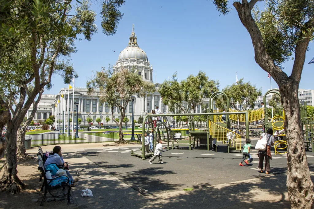 people visit the playground for children in front of the town hall in San Francisco. Adults without children are not allowed to enter the area